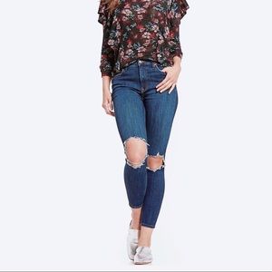 FREE PEOPLE busted knee medium wash jeans.